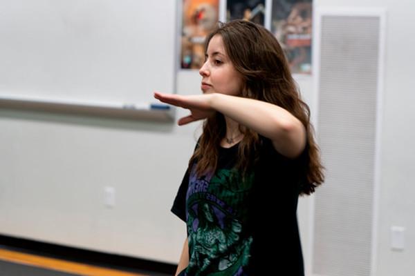 female dancer making angular shape with one arm