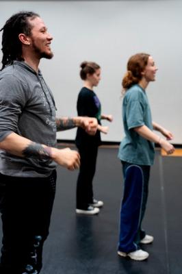 Dance teacher and two students doing popping technique