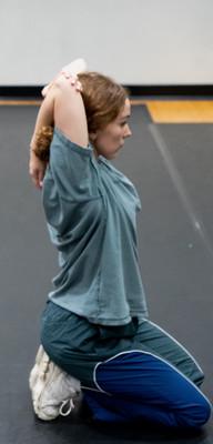 female dancer stretching arm behind head